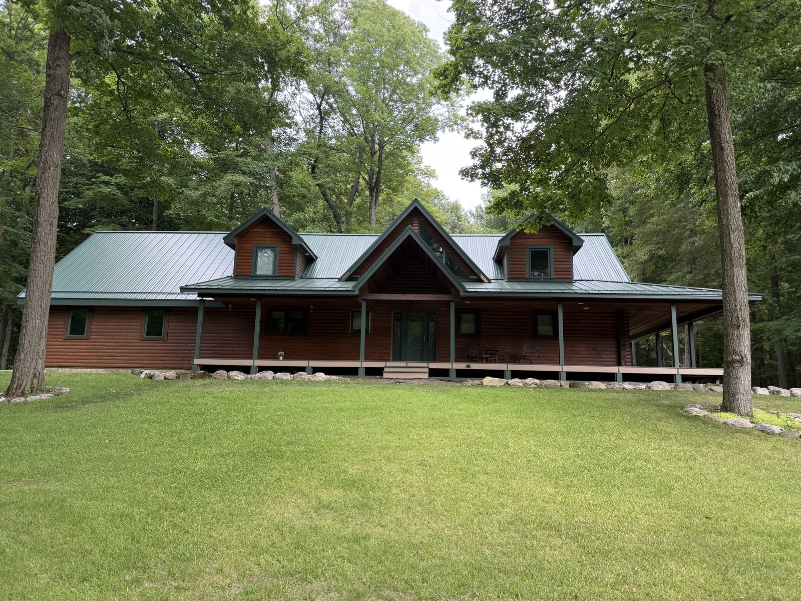 Metal roof on a stone home in the trees